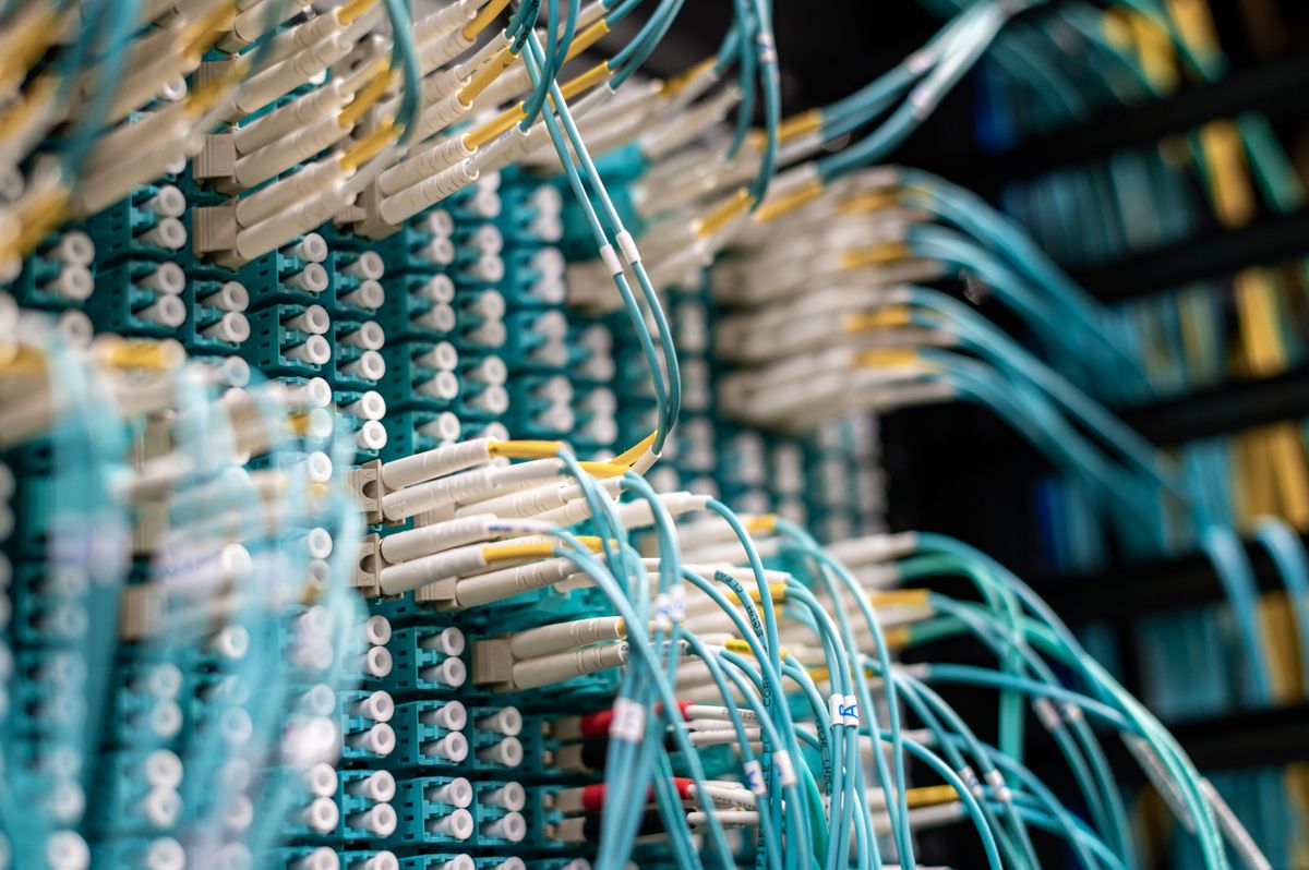 Rows of network server cables representing Newshosting Usenet infrastructure